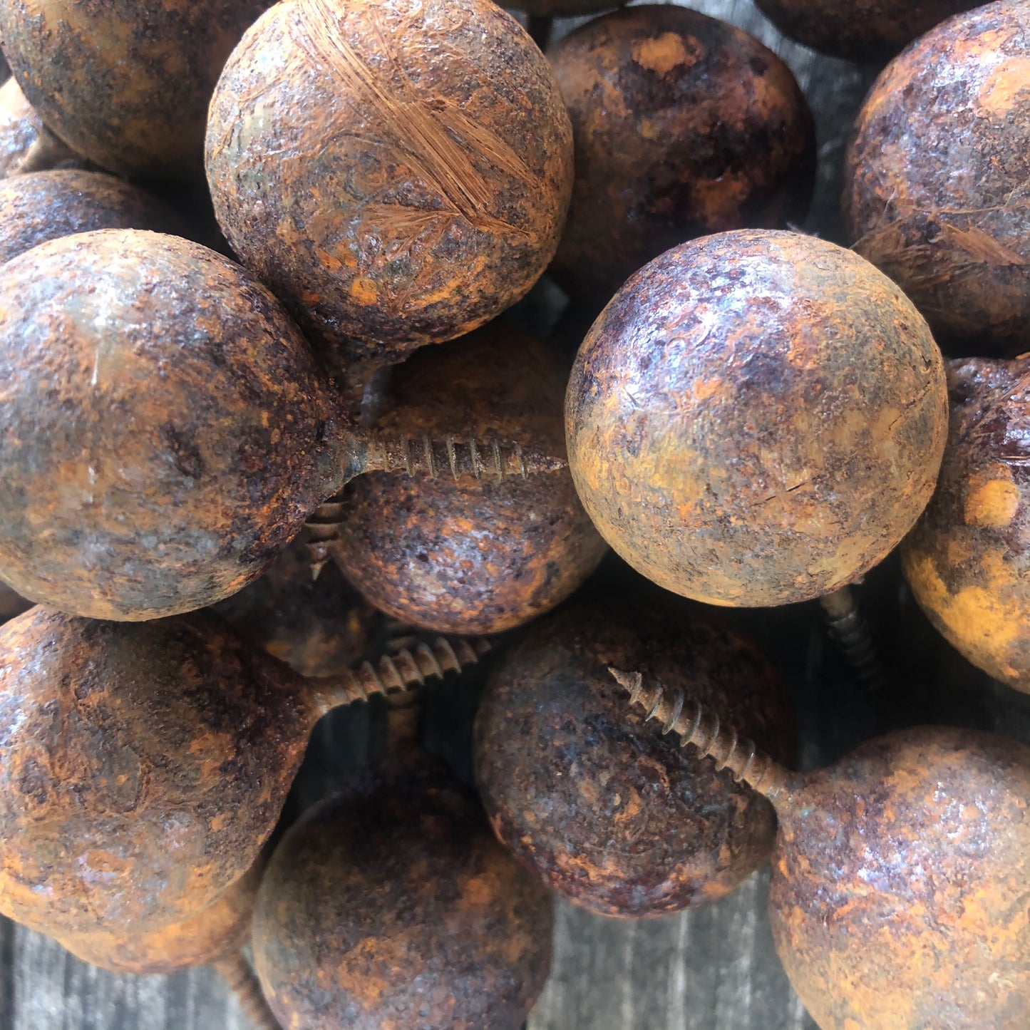 Fifty handmade rusted metal balls with screw attachment in sizes from 1.2 to 3.9 inches - unique decor for walls or fencing