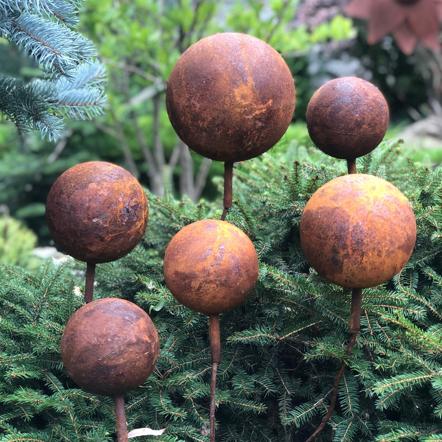 Set of 6 Rusty Metal Balls on Stakes: Unique Rusty Garden Decor for Your Outdoor Space.