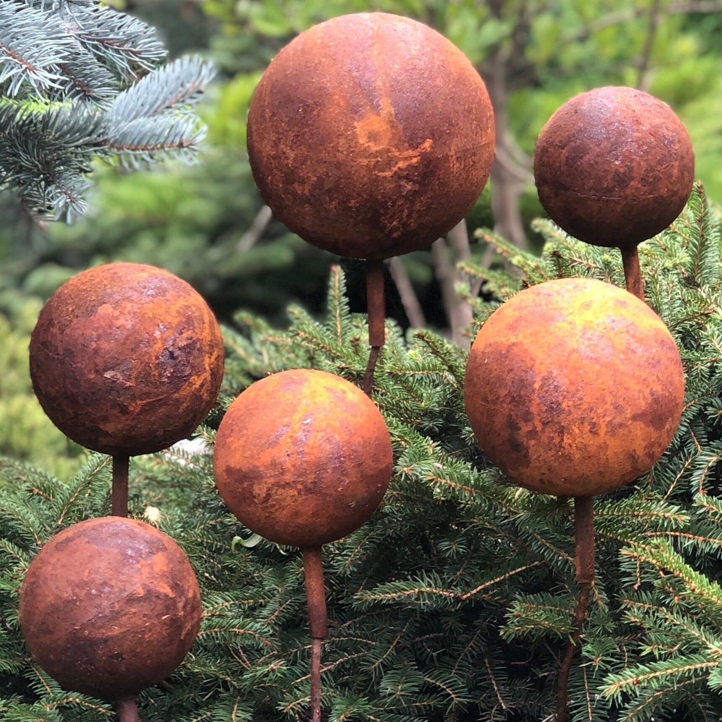 Set of 6 Rusty Metal Balls on Stakes: Unique Rusty Garden Decor for Your Outdoor Space.